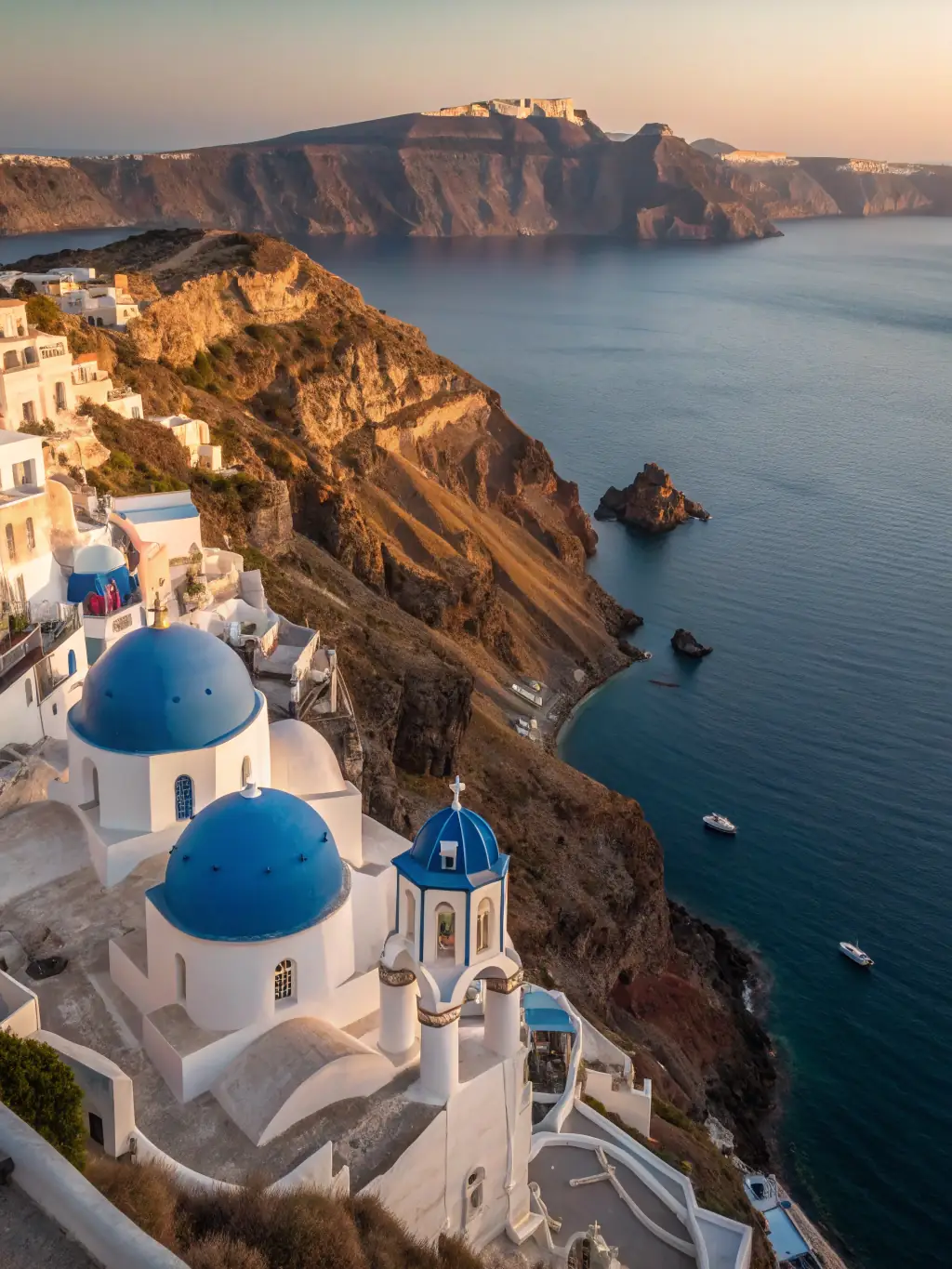 A vibrant photo of Santorini, Greece, showcasing its iconic white buildings and blue domes overlooking the Aegean Sea, capturing the essence of a dream vacation.